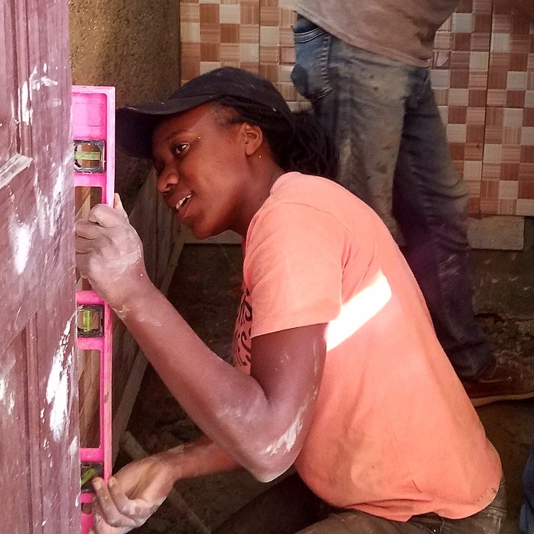 female tiling student on job