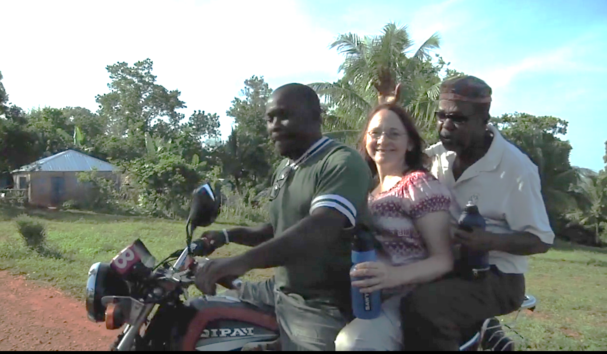 Valerie Mossman-Celestin and Paul Prevost with a colleague on a motorcycle in Mizak, Haiti